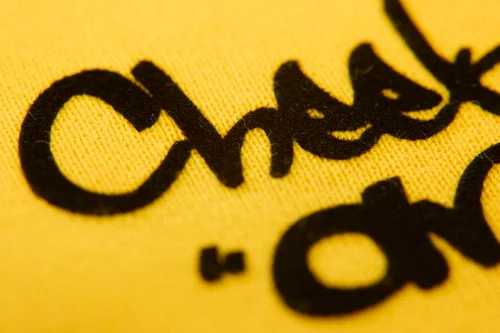 黒いCheeky antの文字がフロッキー加工された黄色いパーカー
